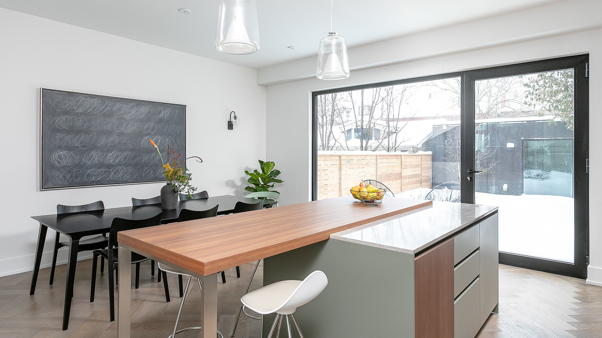 Open kitchen and dining area with sliding patio doors and walnut island