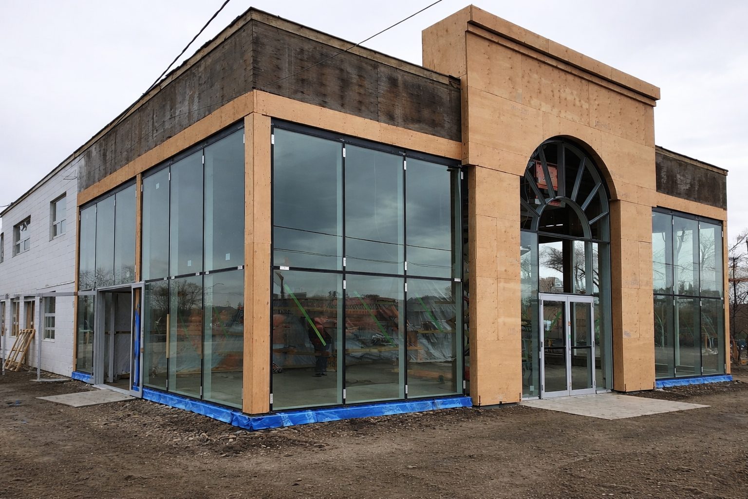 Dealership framing with glass storefront and arched window frame installed