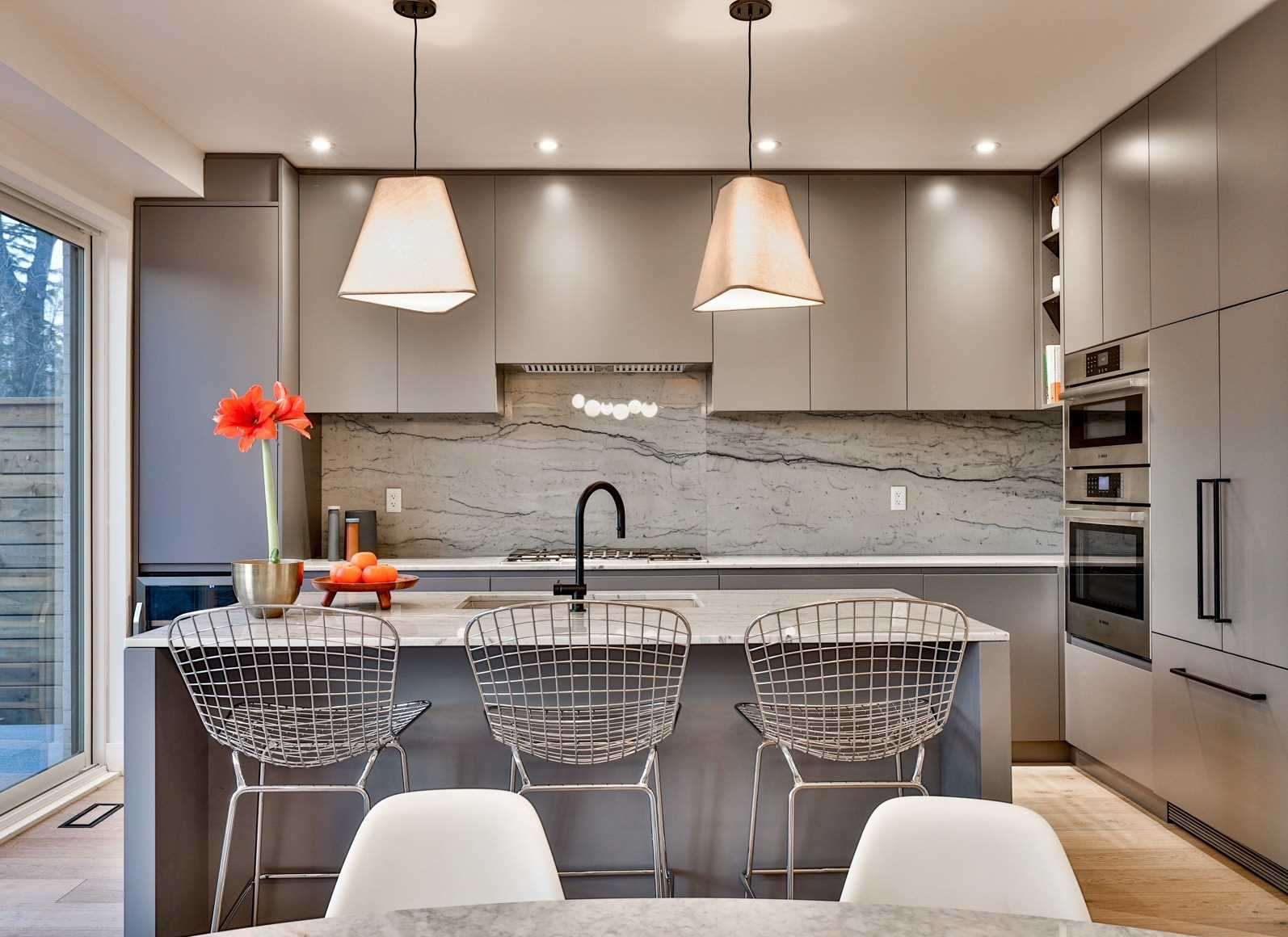 Modern kitchen with pendant lights and stone backsplash