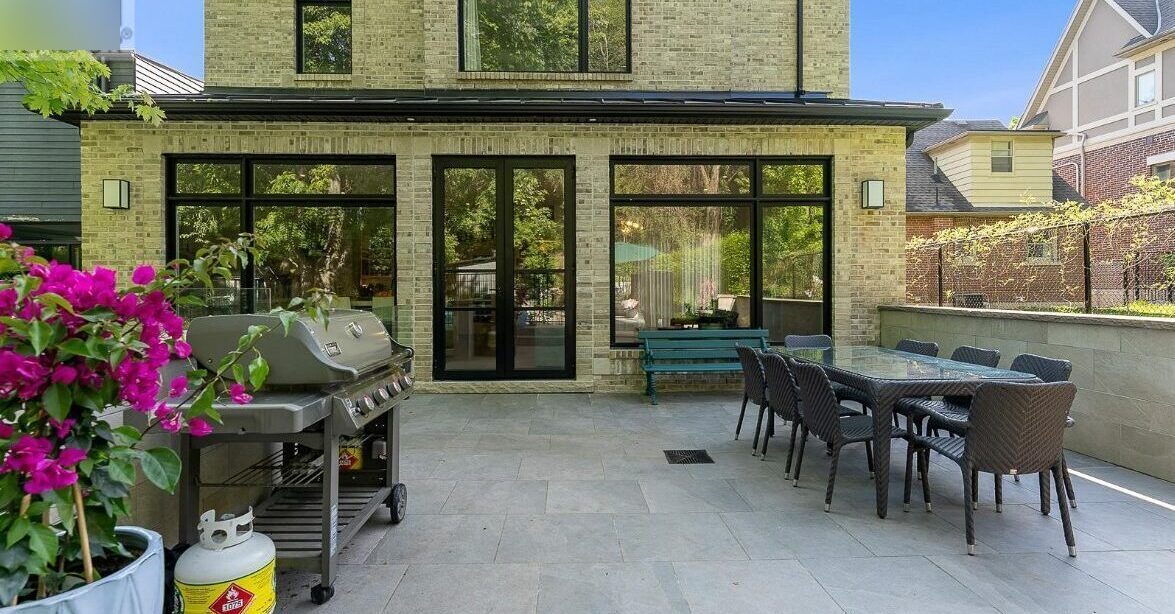 Custom backyard patio with large sliding doors and outdoor dining