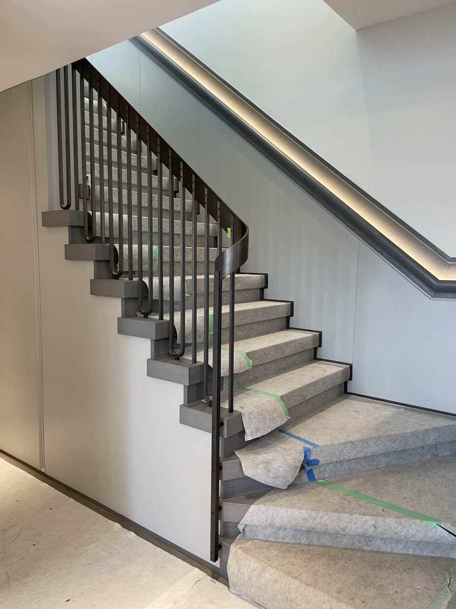 Modern staircase with metal balustrade and LED handrail
