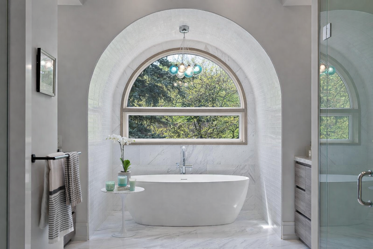 Luxury bathroom renovation with marble arch doorway and freestanding tub in Durham Region